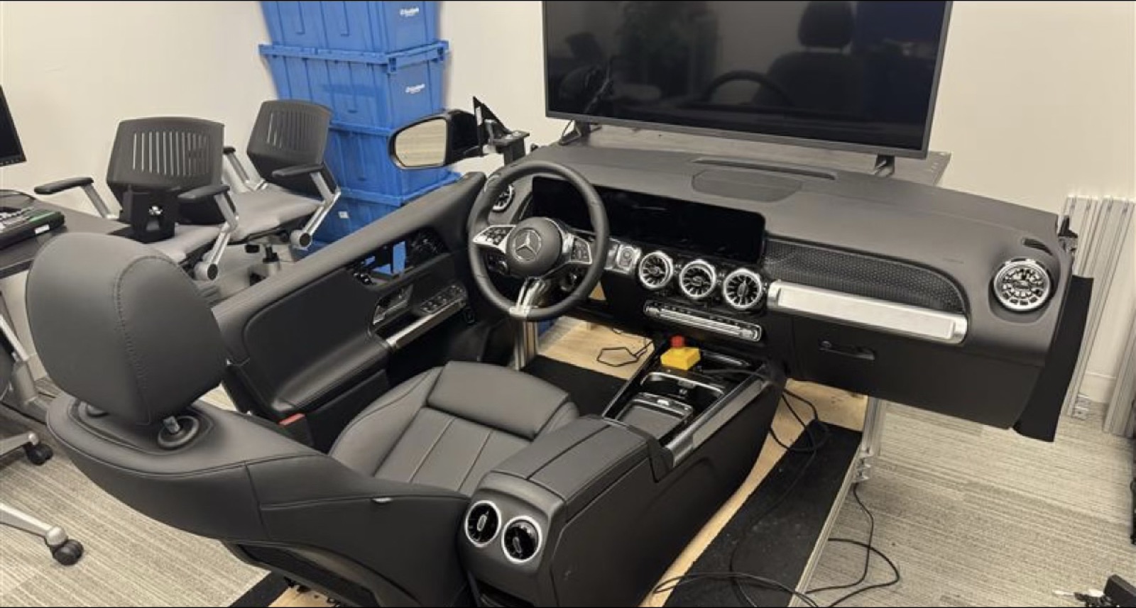 Mercedes seat buck — cabin shell on a rig with a wraparound display.